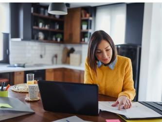 Woman working at kitchen table